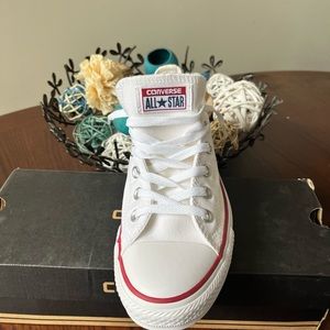 New unisex Converse in all white with red and blue trim around the sole.